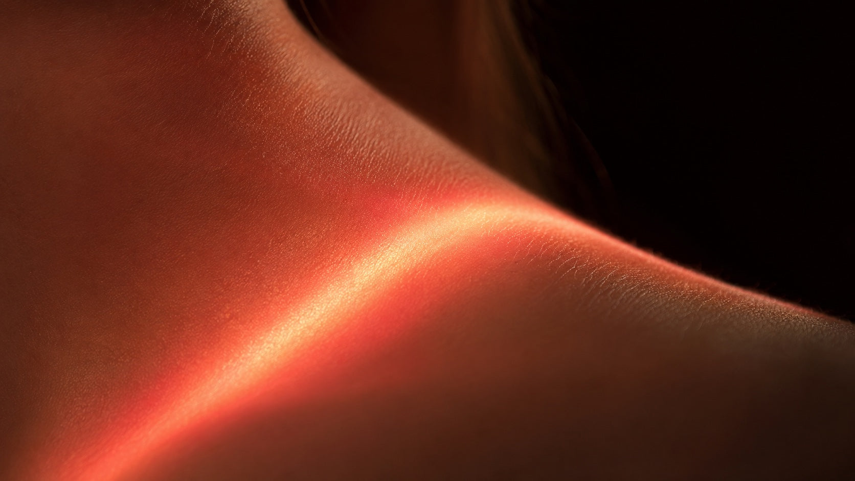 Red light meeting skin — hero close-up (video or image)